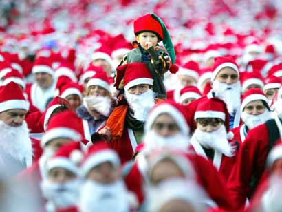 Santas gather in Princes Street Gardens, Edinburgh, to start the Great Scottish Santa Run /PA